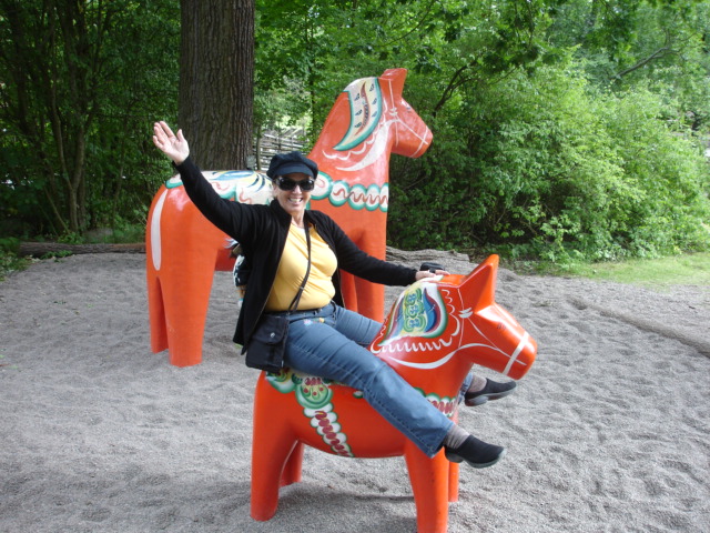 Karen Duquette on a Dala horse in Sweden